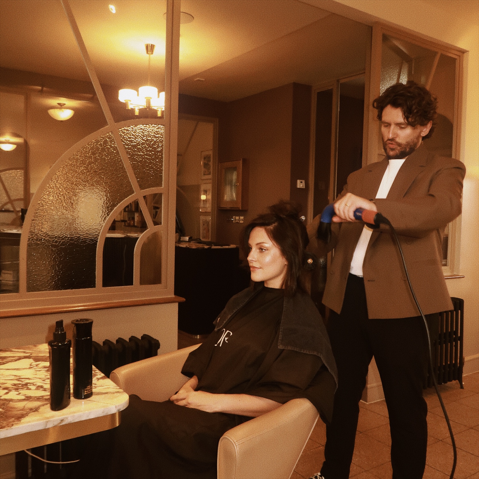 Jack Baxter blow-drying a client’s hair